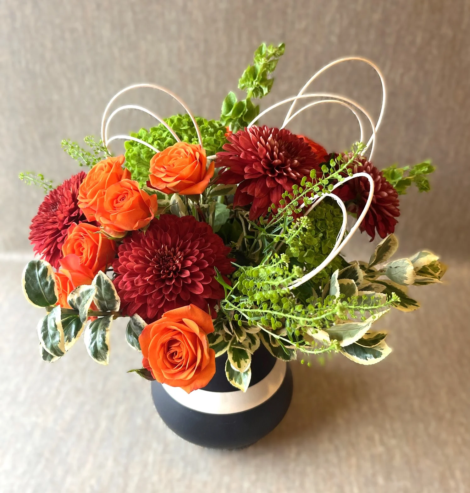 Modern and funky flower arrangement in fashionable vase for reuse